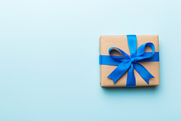 Holiday present box over colored background, top view. Copy space for design