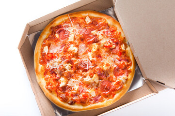 meat pizza lies on a wooden round board on a white background