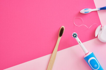 several different types of toothbrushes on a pink background