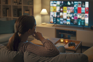 Woman choosing a movie on her television