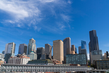 Fototapeta premium Seattle skyline with waterfront view. Skyscrapers of financial downtown at day time, Washington, USA. A vibrant business neighborhood
