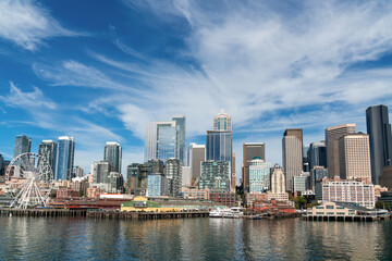 Fototapeta na wymiar Waterfront Seattle skyline with Great wheel view. Skyscrapers of financial downtown at day time, Washington, USA. A vibrant business neighborhood