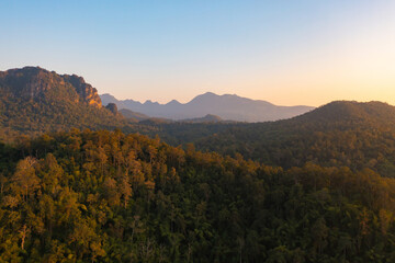 Aerial top view of forest trees and green mountain hills. Nature landscape background, Thailand.