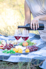 girl in nature drinks wine.
