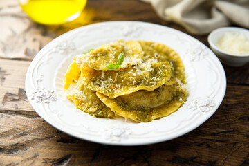 Traditional homemade ravioli with pesto sauce