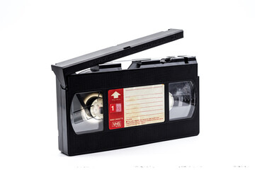 Old VHS cassette with broken tape cover isolated on white