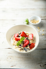 Healthy homemade muesli or oatmeal porridge with strawberry