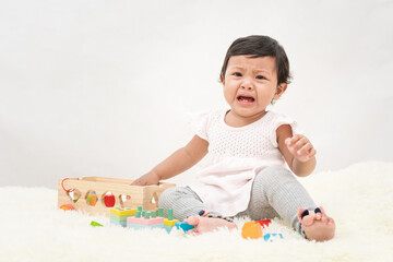 Asia little girl is crying, dissatisfied, needs the love of her parents.