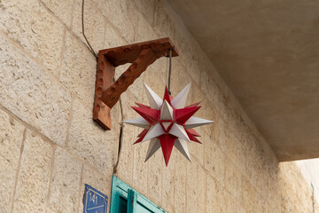 Decorative  plastic star hanging on the wall of a building on Star Street in Bethlehem in the Palestinian Authority, Israel