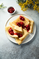 Homemade crepes with raspberry sauce