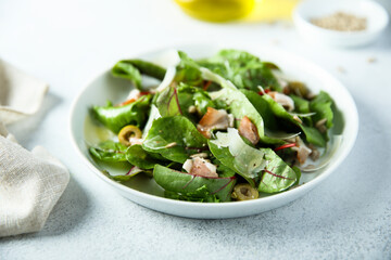 Fresh green salad with olives, bacon and cheese