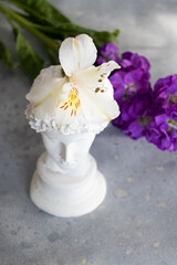 Plaster sculpture of a young guy with flowers