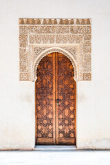 Decorated islamic wooden door in bright light