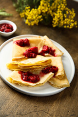 Homemade crepes with raspberry sauce
