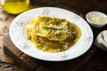Traditional homemade ravioli with pesto sauce