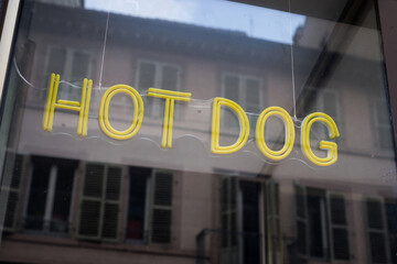 Closeup of hot dog sign on the window of fast food restaurant
