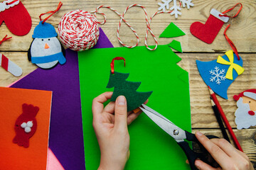 Making handmade Christmas toys from felt with your own hands. Step 2. Cut the toy along the contour.