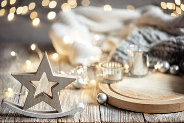 Cozy winter composition with decor details on blurred background with bokeh.