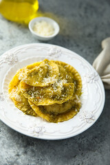 Traditional homemade ravioli with pesto sauce