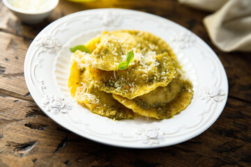 Traditional homemade ravioli with pesto sauce