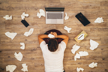 Man with laptop and many handkerchiefs