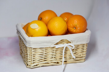 Mock up label on oranges. Wicker basket with oranges and product sticker on it for text or price....