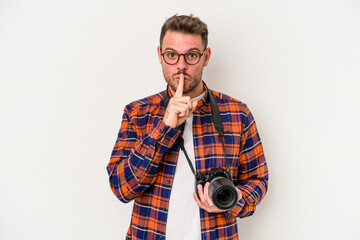 Young caucasian photograph man isolated on white background keeping a secret or asking for silence.