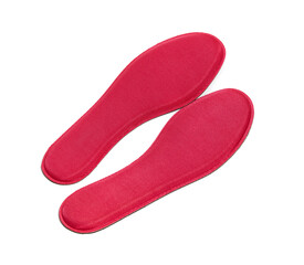 Red memory foam insoles isolated on white background. The insoles adapt to the anatomy of the foot and ensure an ideal distribution of the foot sole’s pressures. 