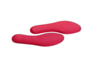 Red memory foam insoles isolated on white background. The insoles adapt to the anatomy of the foot and ensure an ideal distribution of the foot sole’s pressures. 