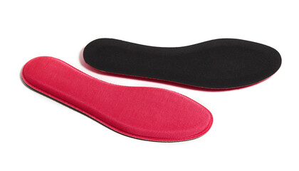 Red memory foam insoles isolated on white background. The insoles adapt to the anatomy of the foot...