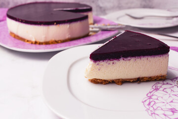 Slice of cheesecake with berries coulis on top and selective focus.
