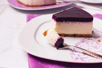 Slice of cheesecake with berries coulis on top and selective focus.