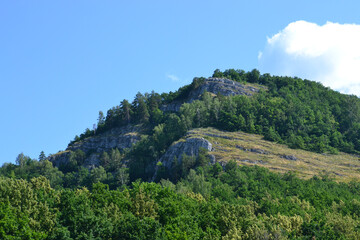 Beautiful green rocks and mountains with a blue sky and clouds