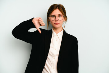 Young business English woman isolated on blue background showing a dislike gesture, thumbs down....