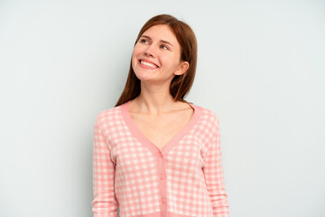 Young English woman isolated on blue background relaxed and happy laughing, neck stretched showing teeth.