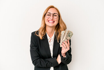 Young business caucasian woman holding banknotes isolated on white background laughing and having fun.