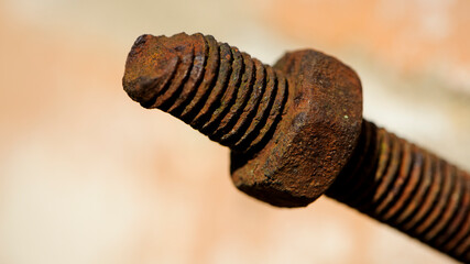 old rusty bolt, iron rod with screw threads. Rusted mechanical components. threaded bolt and nut isolated close up. dismantling concept, difficult to unscrew, non-removable. background selective focus