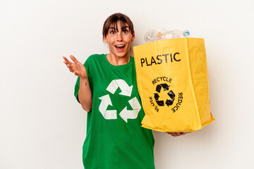 Young Argentinian woman recycled plastic isolated on white background receiving a pleasant...