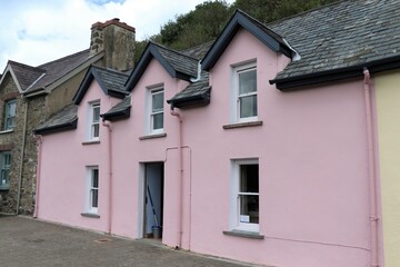 Fototapeta na wymiar Lower Fishguard Harbour View with Traditional Pink Cottages in Pembrokeshire, South Wales, UK