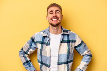 Young caucasian man isolated on yellow background happy, smiling and cheerful.