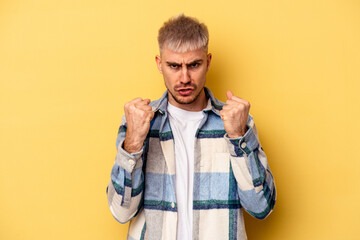 Young caucasian man isolated on yellow background upset screaming with tense hands. - Powered by Adobe