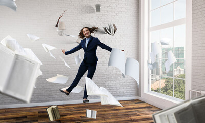 Portrait of energetic businesswoman jumping in open air