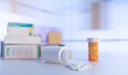 Medical pills and tablets spilling out  drug bottle. View with copy space.