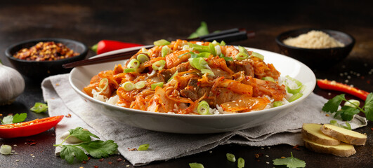 Korean Stir Fried pork belly kimchi with rice and spring onion. Asian food style