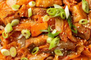 Korean Stir Fried pork belly kimchi with rice and spring onion. Asian food style
