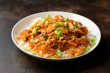 Korean Stir Fried pork belly kimchi with rice and spring onion. Asian food style