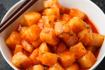 Korean fermented Radish Kimchi in white bowl. Healthy food.