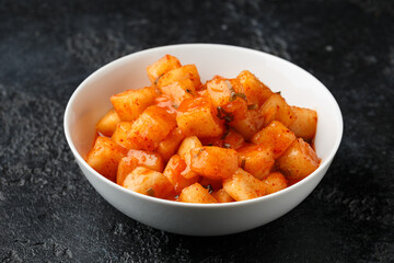 Korean fermented Radish Kimchi in white bowl. Healthy food.