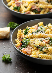 Fusilli pasta with bacon, kale and parmesan cheese. Healthy food