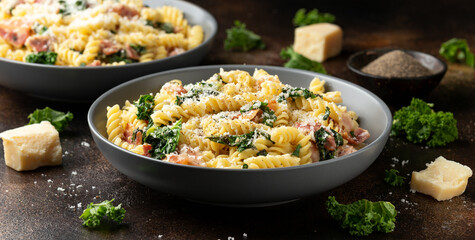 Fusilli pasta with bacon, kale and parmesan cheese. Healthy food - obrazy, fototapety, plakaty